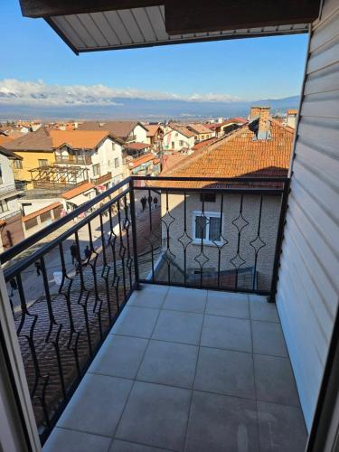 a balcony with a view of a city at Cтаи за гости Бърдареви in Bansko