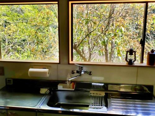 a kitchen with a sink and two windows at Karin no oyado - Vacation STAY 30422v in Takamatsu