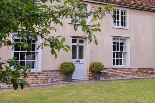 a house with a white door and windows at Retreat East in Ipswich