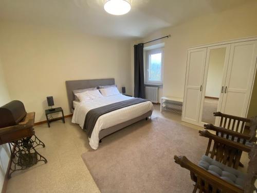 a bedroom with a large bed and a window at 1929 Wine Food Relax Agriturismo in Acqui Terme