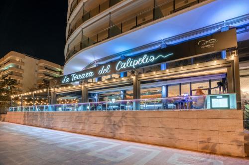 a store front of a building at night at Calipolis in Sitges