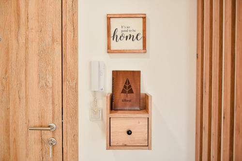 a door with a picture and a box on a wall at 4Rest & 4Joy in Zlatibor