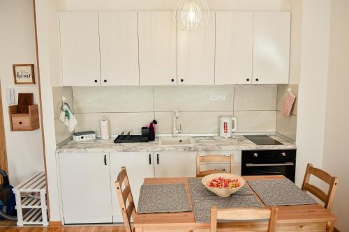 a kitchen with a table with a bowl of fruit on it at 4Rest & 4Joy in Zlatibor