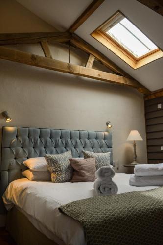 a bedroom with a large bed with a skylight at Retreat East in Ipswich
