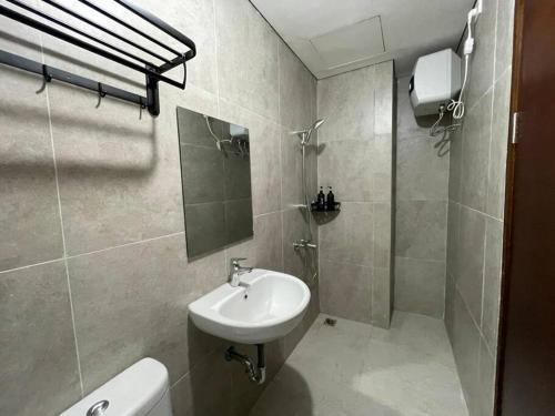 ein Bad mit einem Waschbecken, einer Dusche und einem WC in der Unterkunft Cozy Studio Unit in Casaren in Batam Center