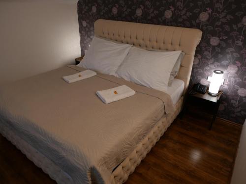 a bedroom with a bed with two towels on it at Hotel Radnice in Liberec