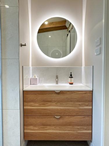 a bathroom with a sink and a mirror at Brigadoon Cottages in Haunted Hills