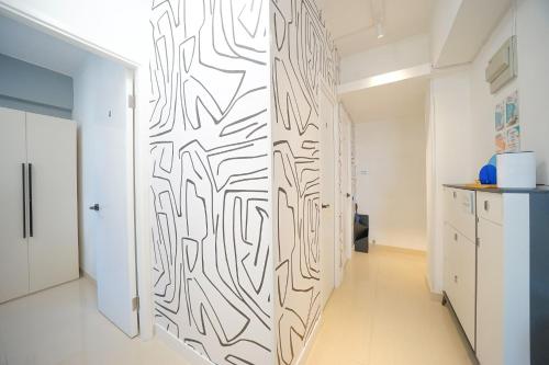 a hallway with a wall with a black and white pattern at Student Accommodation - 290 Hennessy Road in Hong Kong