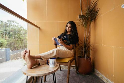 a woman sitting in a chair reading a book at Draper Startup House for Entrepreneurs Hyderabad in Hyderabad