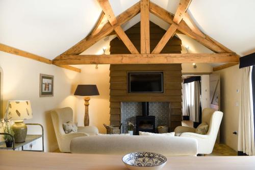 a living room with a couch and a fireplace at Retreat East in Ipswich