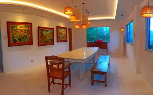 a dining room with a table and chairs at Club Monet Beachfront Resort by Cocotel in Zambales