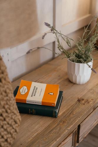 a book sitting on a table with a plant at Retreat East in Ipswich