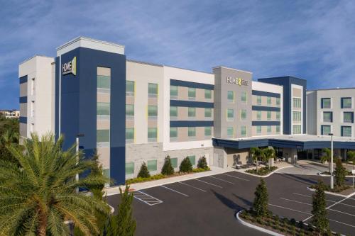a rendering of a hotel with a parking lot at Home2 Suites Orlando Southeast Nona in Orlando