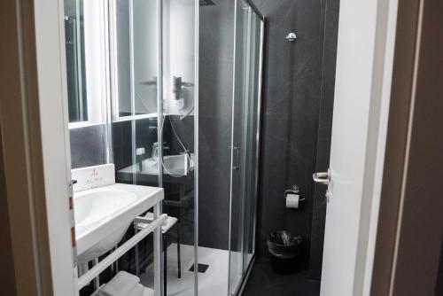 a bathroom with a sink and a shower at Alma Hotel in Palermo