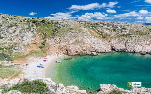 an aerial view of a beach with people in the water at Villa Valis in Baška