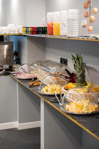 a counter with plates of food on it at Alma Hotel in Palermo