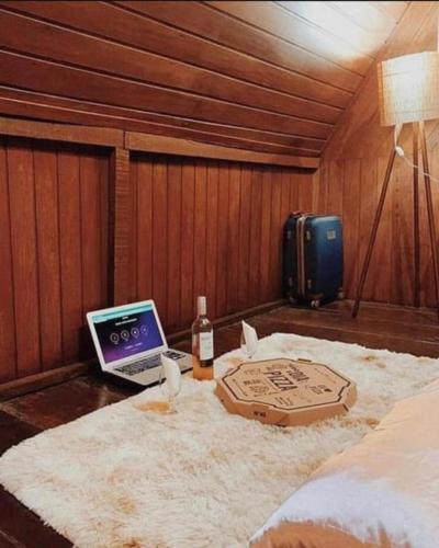 a bedroom with a bed with a laptop on a table at Chez Max Pousada in Morro de São Paulo