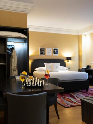 a hotel room with a bed and a table and chairs at Elizabeth Lifestyle Hotel in Bologna