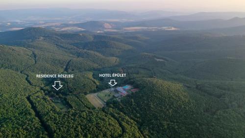 an aerial view of a house in the middle of a forest at Szent Orbán Erdei Wellness Hotel és Residence in Kóspallag