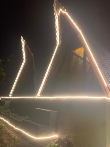 a building with lights on it at night at Tukadsari camping in Kintamani