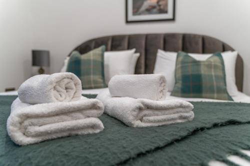 a pile of towels sitting on top of a bed at NEW Luxury family/dog-friendly countryside retreat in Kirkby Thore