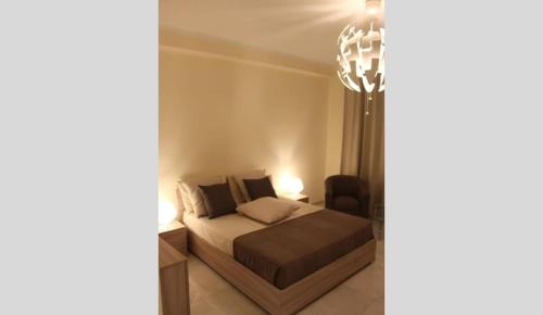 a bedroom with a bed and a chandelier at Appartamento Lungo Il Canale - Via Trento - 6 persone in Trieste