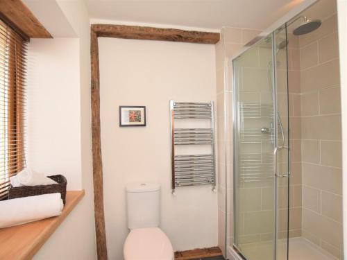 a bathroom with a toilet and a glass shower at 3 bed property in Bovey Tracey 52042 in Bovey Tracey
