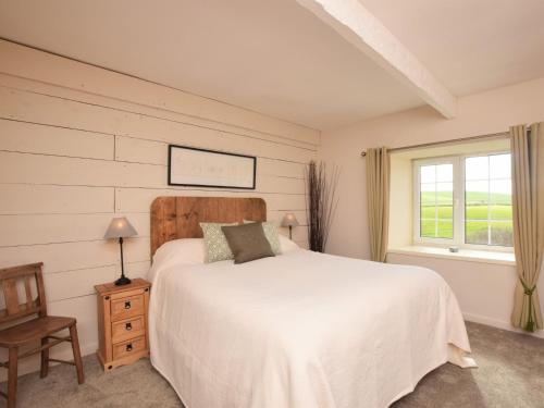 a bedroom with a white bed and a window at 2 Bed in Nr Gibside CN080 in Whickham