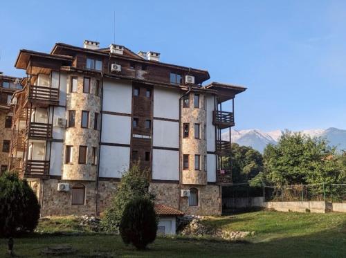 an old building in the middle of a field at Apartment in Sapphire Residence in Bansko