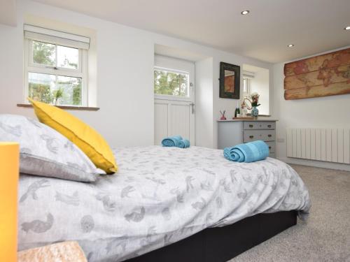 a bedroom with a large bed with blue pillows at 1 Bed in Durham 76615 in Lanchester