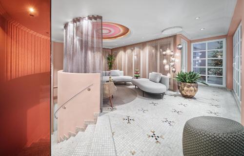 a lobby with a staircase and a living room at Hotel Weisses Roessl in Kitzbühel