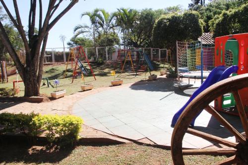 a park with a playground with a swing set at Villa Verde Hotel in Avaré