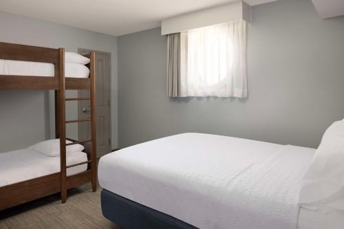 a bedroom with a bed and a bunk bed at Hampton Inn & Suites Myrtle Beach Oceanfront in Myrtle Beach