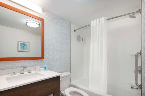 a bathroom with a sink and a toilet and a shower at Hampton Inn & Suites Myrtle Beach Oceanfront in Myrtle Beach