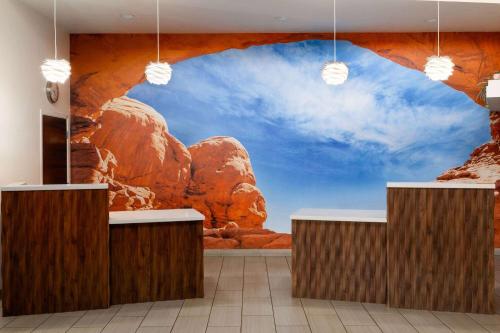 a lobby with a mural of a mountain at Wingate by Wyndham Cedar City in Cedar City