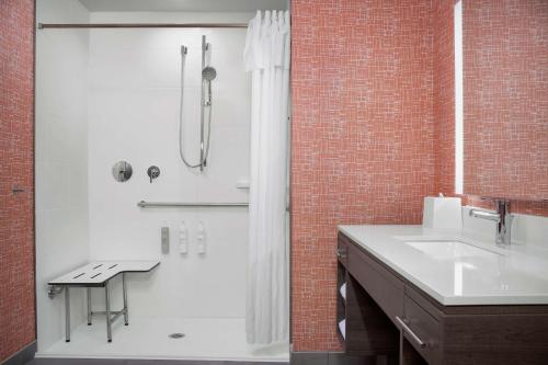 a white bathroom with a shower and a sink at Home2 Suites By Hilton Cullman in Cullman