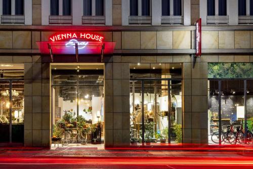a store front of a building at night at Vienna House Easy by Wyndham Leipzig in Leipzig