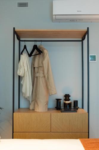 a closet with a dresser in a bedroom at Nôma Living Icon Apartments in Porto