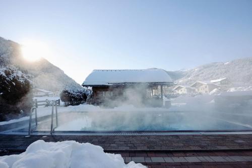 a pile of snow next to a building with steam at Hotel loj - our kind of place in Flachau