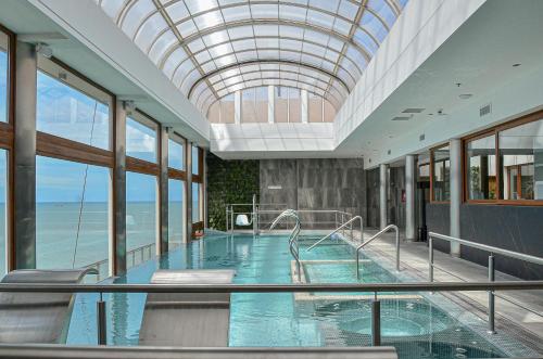 a large swimming pool with a glass ceiling at HOTEL KONKE MAR DEL PLATA in Mar del Plata