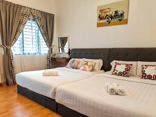 a bedroom with two beds with white sheets at W25 atGoldenHills NightMarket WiFi 4R in Brinchang