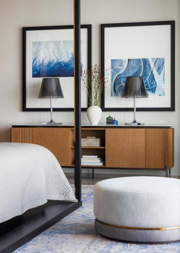 a bedroom with a bed and a table and a mirror at One&Only One Za'abeel in Dubai
