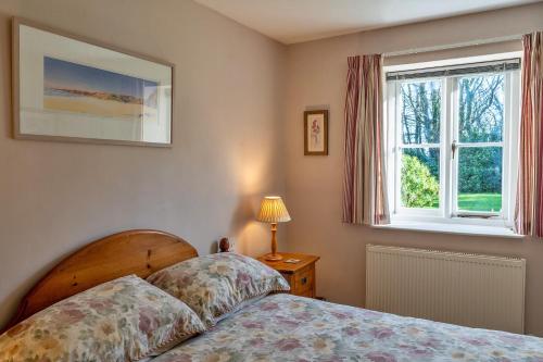 a bedroom with a bed and a window at Finest Retreats - Swallows at St Keverne in Saint Keverne