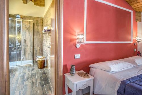a bedroom with a red wall and a bed and a shower at Amore Rentals - Appartamento Caruso in Sorrento