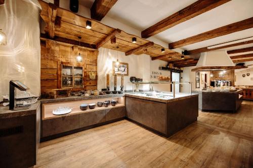 a large kitchen with wooden walls and wooden floors at BERGZEIT by seven in Flachau