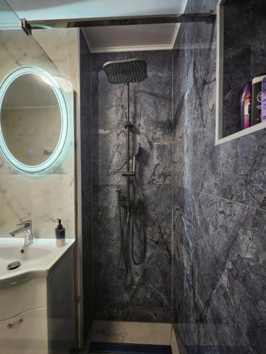 a bathroom with a shower and a sink at Blue Apartament Braila in Brăila
