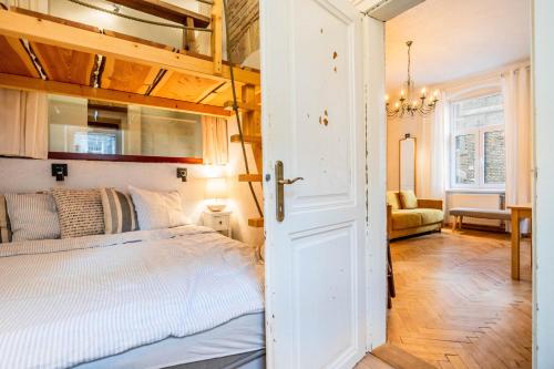 a bedroom with a bed and a open door at Historical Wine Apartment in Bratislava