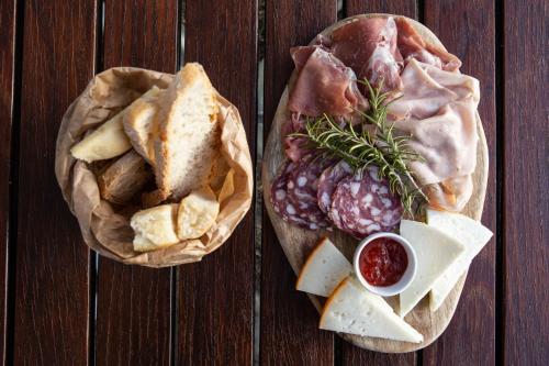two baskets of food with meat and cheese on a table at Agriturismo Podere L'Agave in San Vincenzo