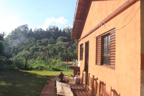 a dog sitting on the porch of a house at Refúgio Leve Amor in Águas de Lindóia
