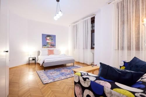a living room with a couch and a bed at Caragiale Apartment in Bucharest